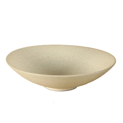 Speckled clay handcrafted ceramic pasta bowl in cream with wide rim and footed base, shown on white background — Speckled Sand variant