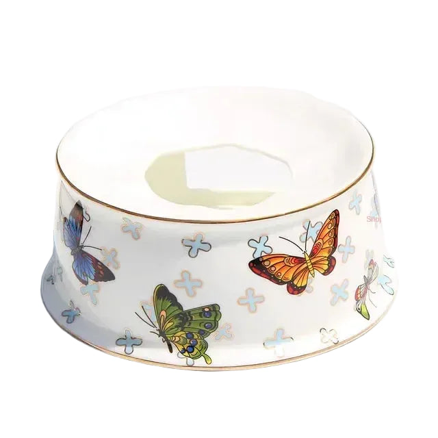 (Tea Warmer):

"White bone china tea warmer with butterfly print and gold rim, candle holder base — CL House"