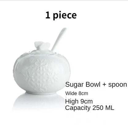 (Sugar Bowl):

"White embossed bone china sugar bowl with lid, floral relief and spoon — CL House Tea Time"