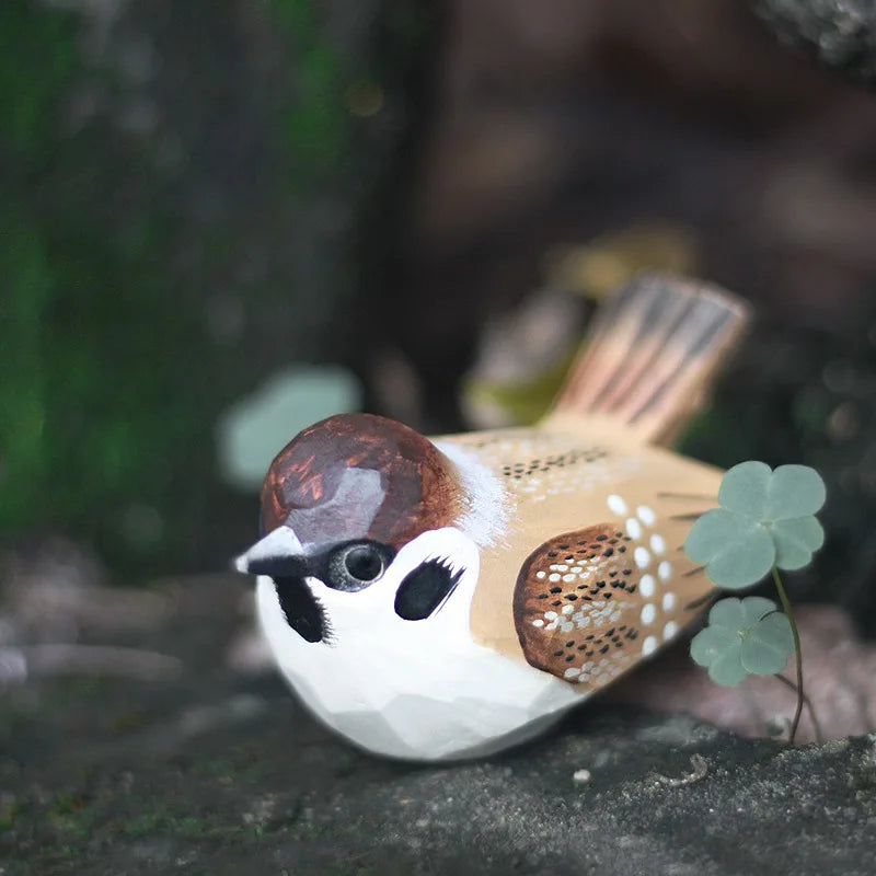 "Little Sparrow" hand-carved wood bird figurine peeking through stone crevice, detail of painted plumage, CL House