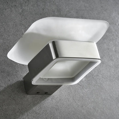 Close-up detail of wall-mounted frosted glass soap dish showing brushed nickel stainless steel bracket and mounting screws on grey concrete wall