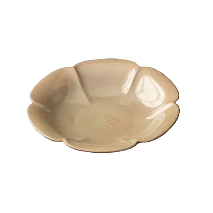  Charcoal stoneware ceramic dish in petal shape with bronze reactive glaze, close-up view, dark grey background