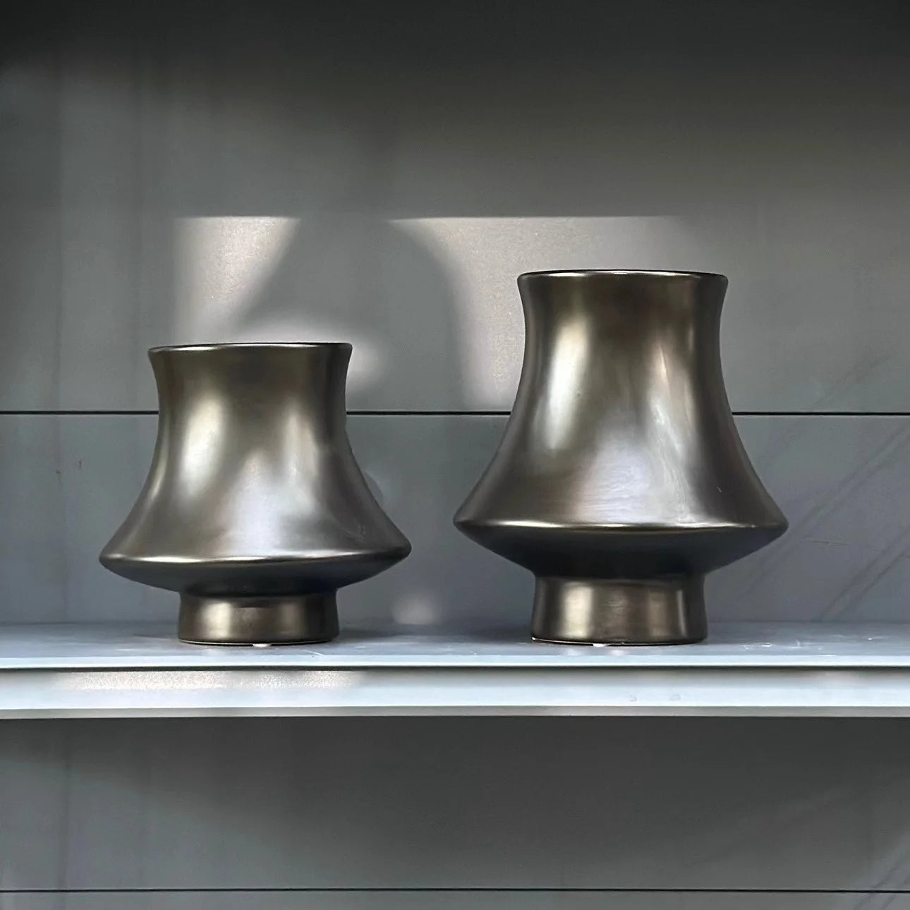  Bell Tower metallic ceramic vases in Gunmetal finish, Small and Large sizes side by side on grey shelf