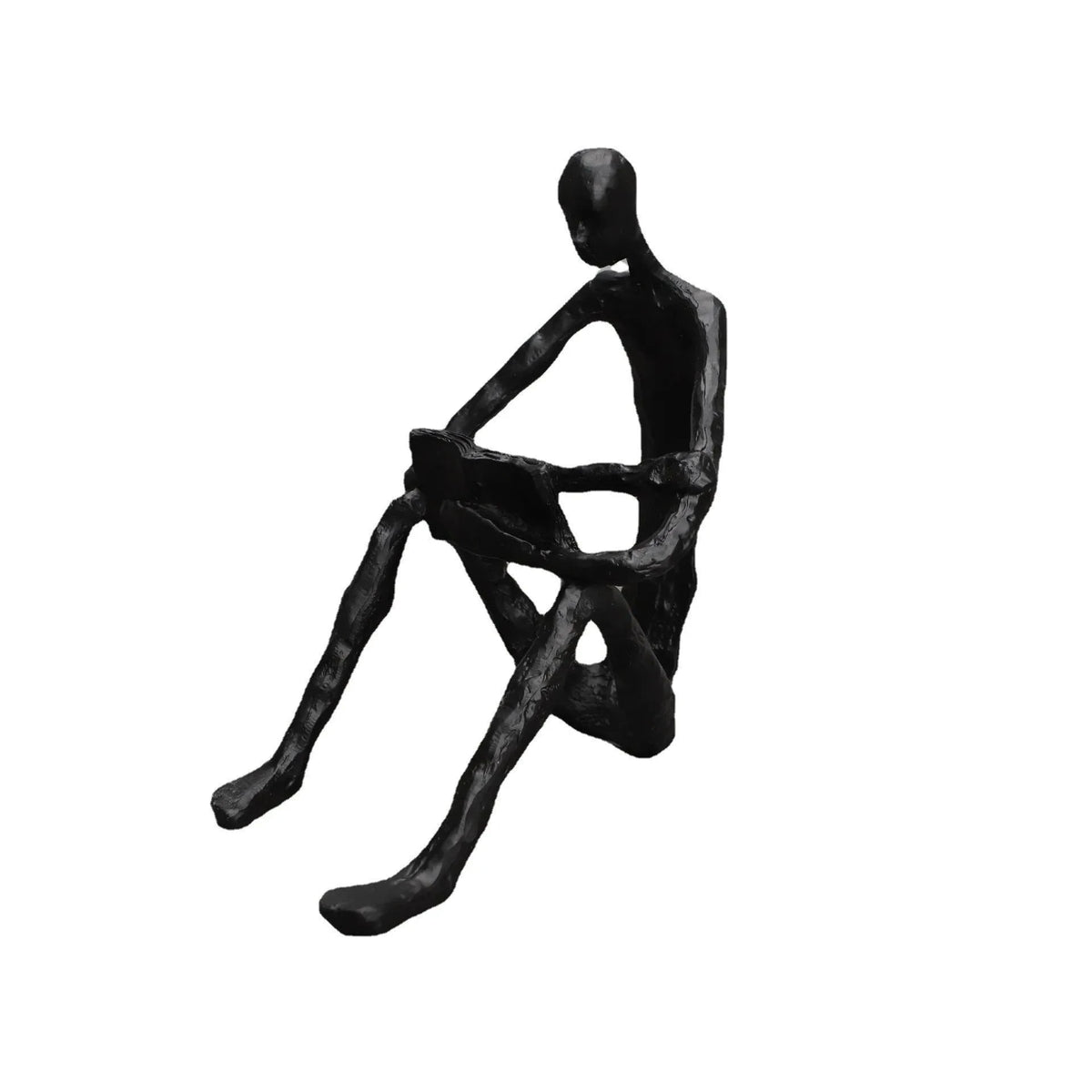 Abstract seated reader sculpture in matte black metal, shown with dimensions of 17 cm tall, 15 cm deep and 10 cm wide