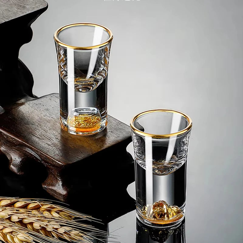 Two "Gold Sculpture" crystal shot glasses in Waist variant together on a table — CL House Drinkware collection