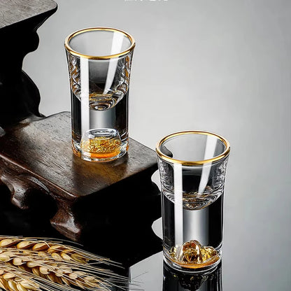 Two "Gold Sculpture" crystal shot glasses in Waist variant together on a table — CL House Drinkware collection