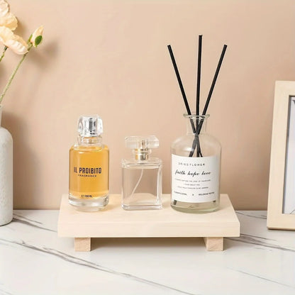  Natural pine wood elevated vanity tray on marble surface holding perfume bottles and reed diffuser, warm beige wall background — japandi bedroom or bathroom styling