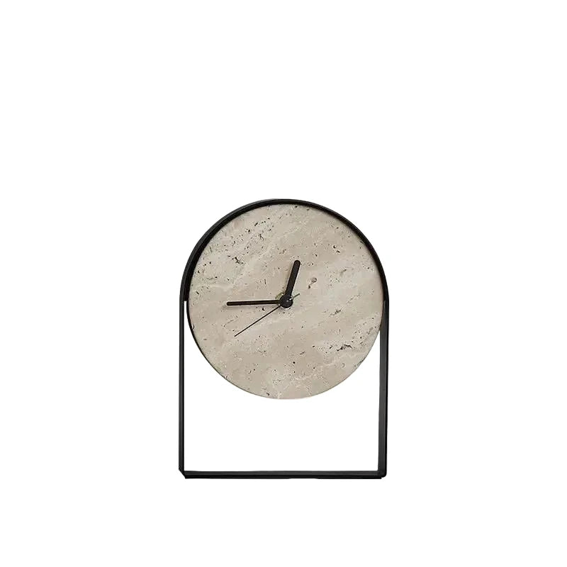 Black arched metal table clock with a round travertine stone dial and slim black hands, on a plain white background