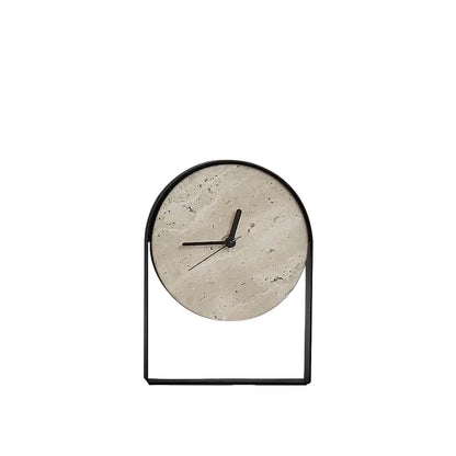 Black arched metal table clock with a round travertine stone dial and slim black hands, on a plain white background