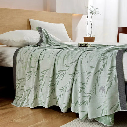 "100% Bamboo Fibre cooling blanket in Willow Mist — sage green willow leaf print on mint green background with dark grey border, lightweight summer throw styled on a bed"