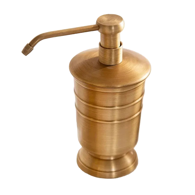 Antique brass soap dispenser with pump, ridged cylindrical body and domed lid, brushed warm gold finish, white background