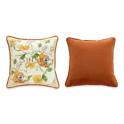  "Shine" botanical velvet cushion cover front and back view, cream ground with watercolour florals in amber, yellow and orange, typographic "SHINE" centre, plain burnt orange velvet reverse with coordinating piping — CL House Cushions collection