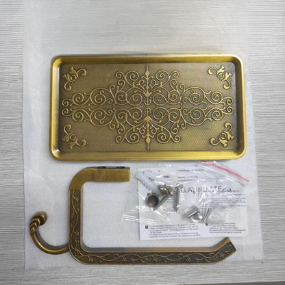  Antique gold toilet paper holder disassembled showing engraved shelf tray, paper roll bracket and installation hardware kit, grey background