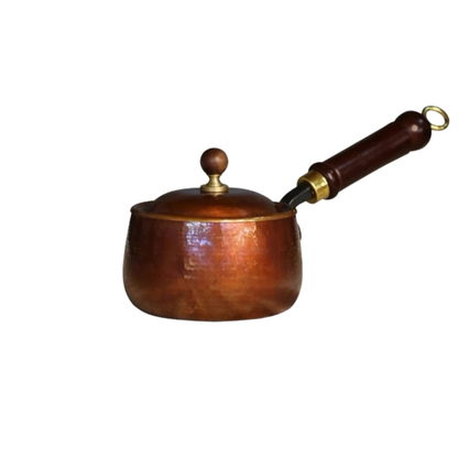  Hand-hammered pure copper saucepan with domed copper lid, dark wooden handle with brass fitting and hanging ring on white background — side view showing hammered texture and warm copper patina — Copper Forge Saucepan by CL House