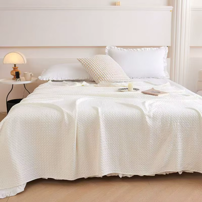 "100% Bamboo Fibre waffle-texture cooling blanket in Ivory White draped over a bed in a serene minimalist bedroom — styled with mushroom lamp, candle and book, elegant summer bedding"