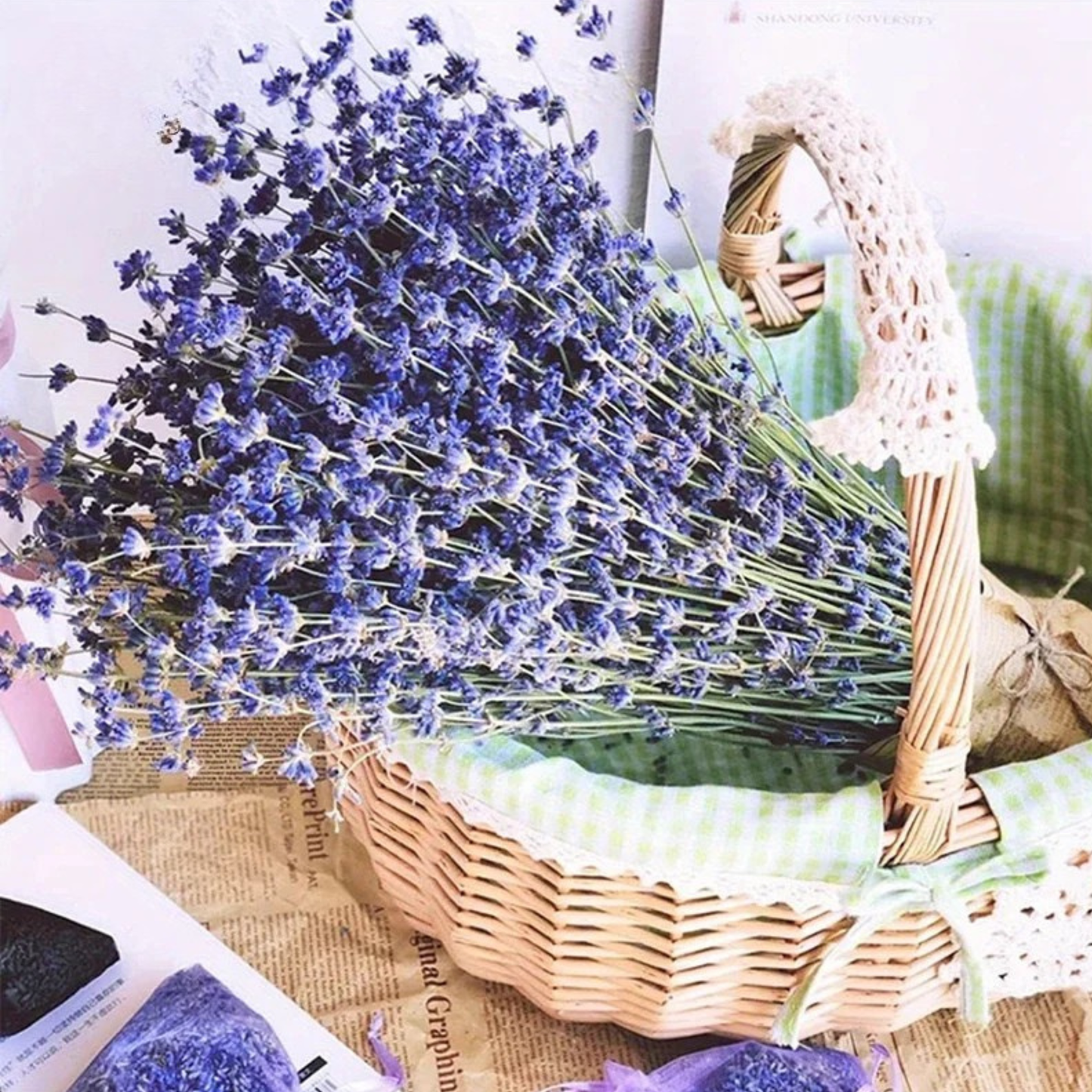 "Lavender Fields" dried lavender bouquet arranged in a wicker basket with lace trim, styled on a vintage newspaper with lavender sachets