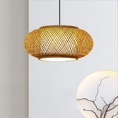 "Weave & Disc" hand-woven bamboo pendant light with open lattice disc shade glowing warm amber light, black cord, neutral beige background