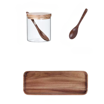  Flat lay of the complete set components — glass jar with acacia wood lid and spoon inside, individual wooden spoon, and rectangular acacia serving tray — white background showing all pieces included in the Acacia & Glass Spice Jar Set by CL House
