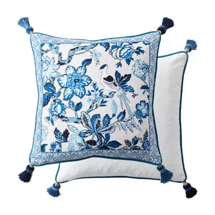 "Blue Willow" chinoiserie linen cushion cover — white ground with blue botanical print, bird among peonies and magnolias, blue tile border and corner tassels, 45×45cm — CL House