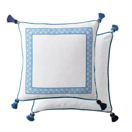 "Blue Willow" chinoiserie linen cushion cover — white ground with blue tile border frame, teal piping and corner tassels, 45×45cm — CL House